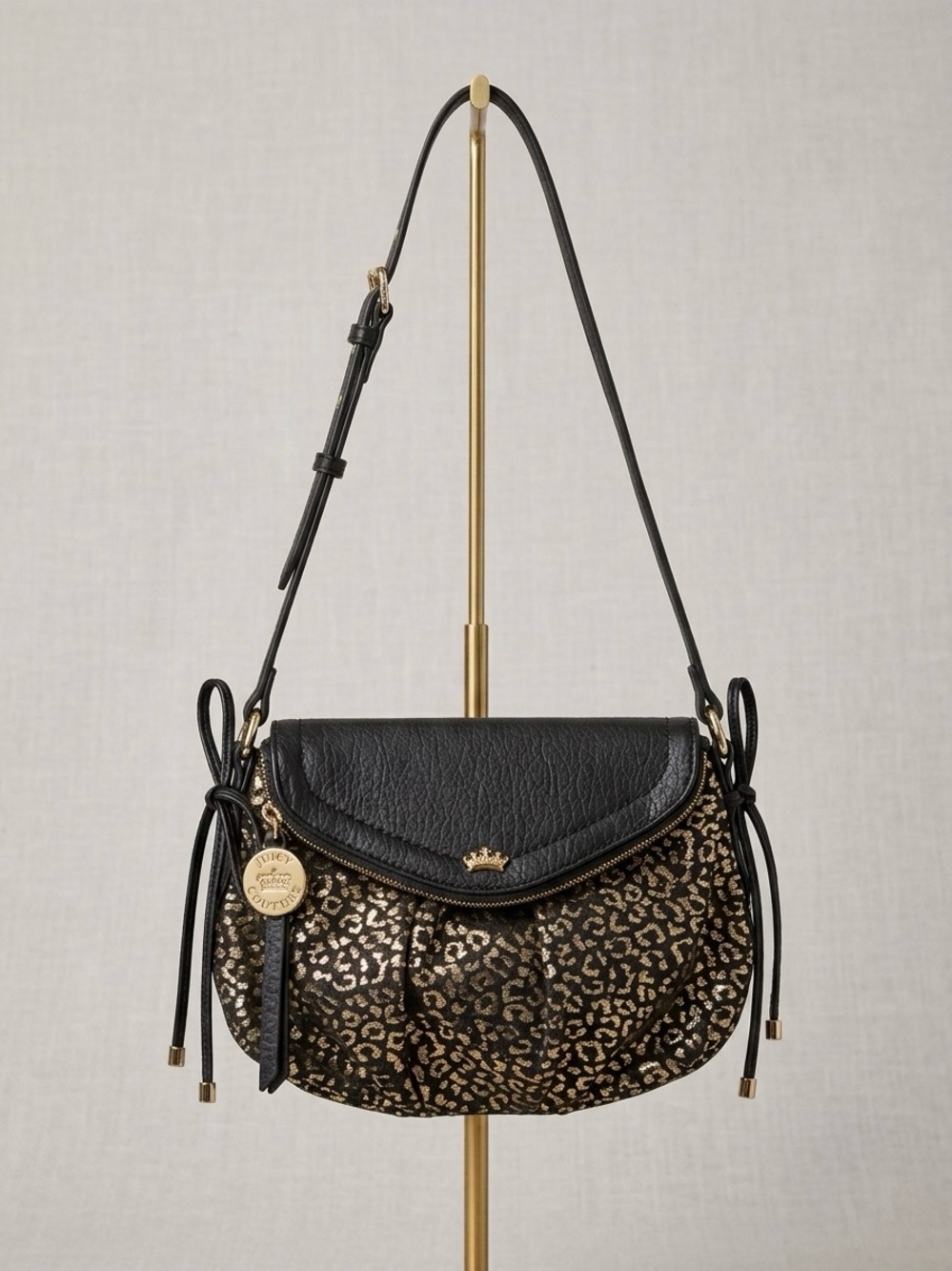 Juicy Couture black pebbled faux-leather and metallic gold leopard-print bag.